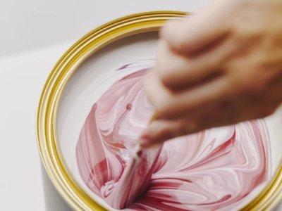 Picture of pink and red pigments being mixed into paint